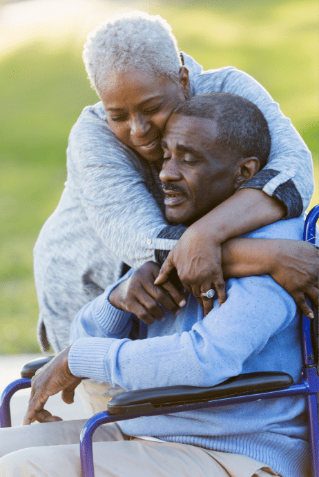 woman hugging a man in a wheelchair