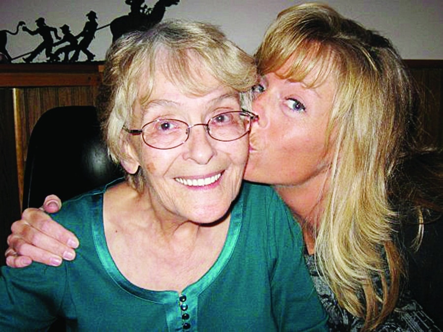 Rachel Hahn gives a loving kiss to her mother, who was a patient of Cedar Valley Hospice's.